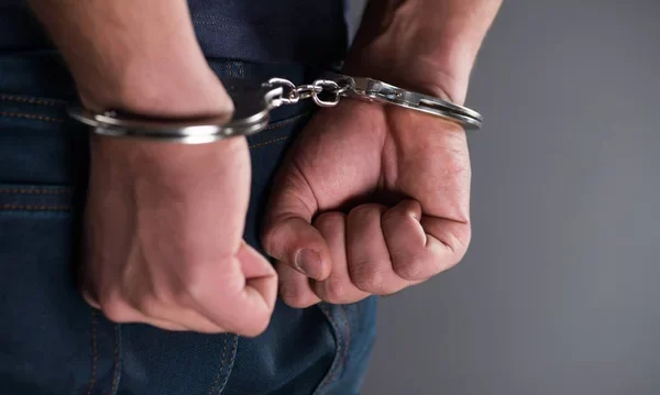 depositphotos_169815564-stock-photo-man-with-his-hands-handcuffed